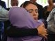 Newzealander PM Jacinda Ardern hugs a member of the grieved families